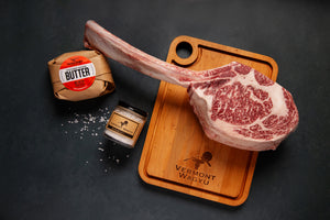 Vermont Wagyu Tomahawk steak on a Vermont Wagyu cutting board with Ploughgate Farm Butter and Heirloom Finishing Salt. 